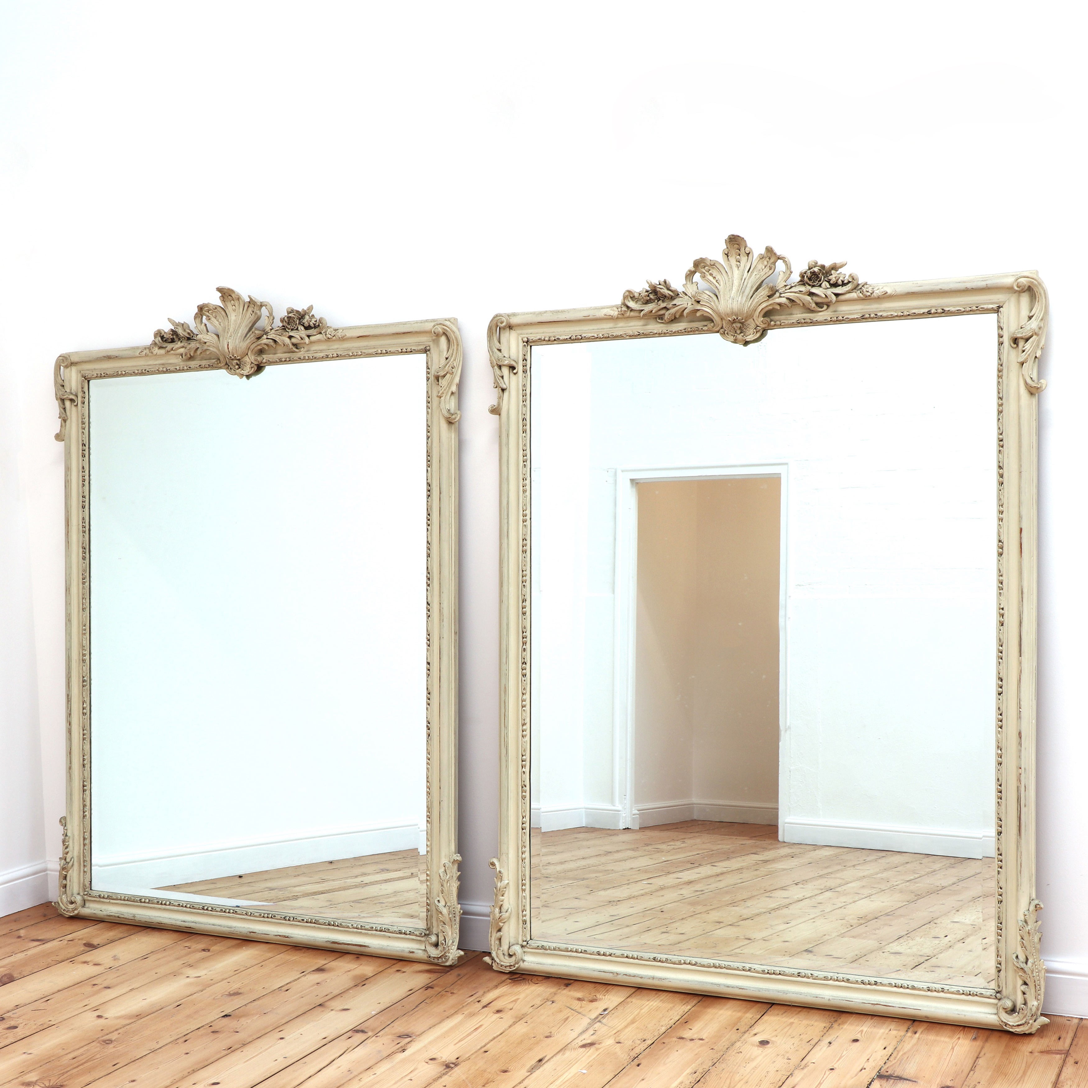 A pair of white painted mirrors